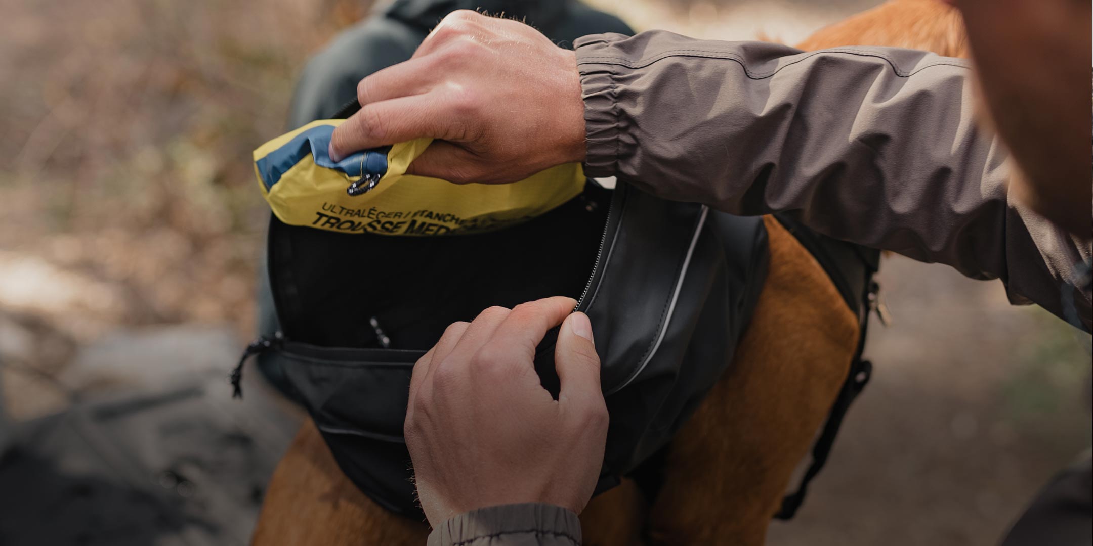 man loading his Ascension dog pack prior to going on a hike