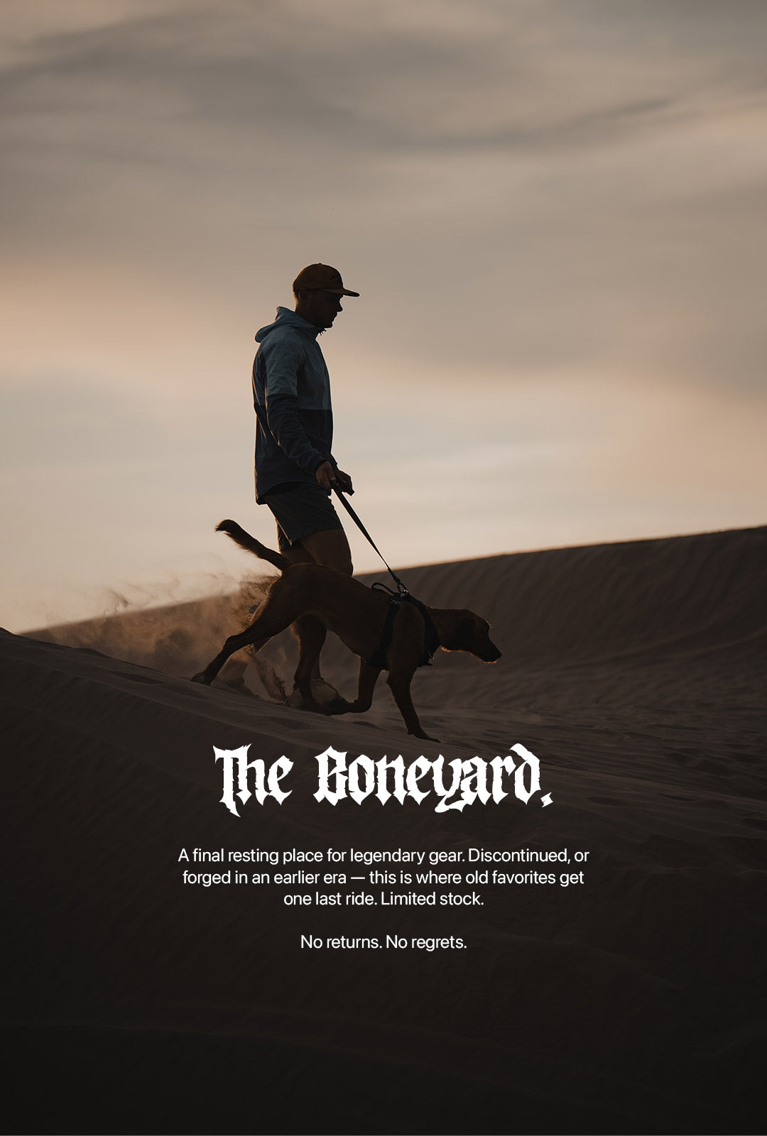 Man walking his dog in the desert with a Saker harness