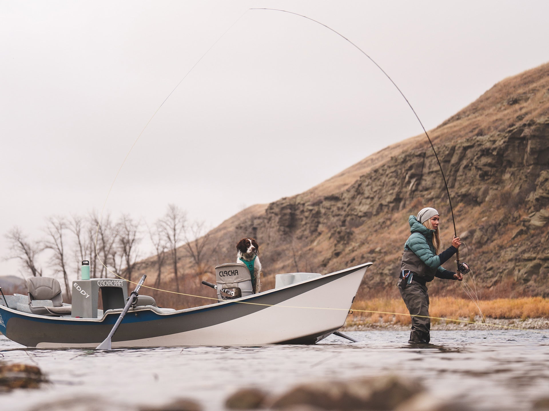 Paula Shearer fishing on the Bow River with her dog Willow