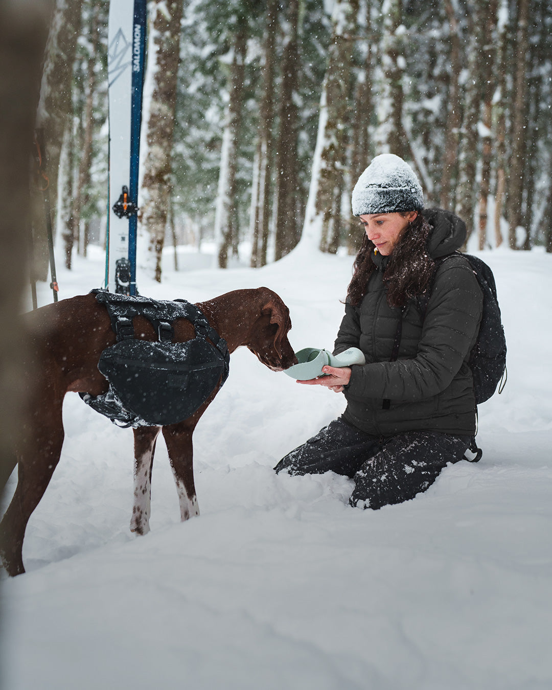 Woman giving water to her dog with the Slurpy Sack 2.0