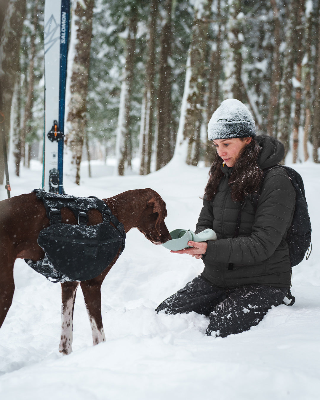 Woman giving water to her dog using the Slurpy Sack 2.0