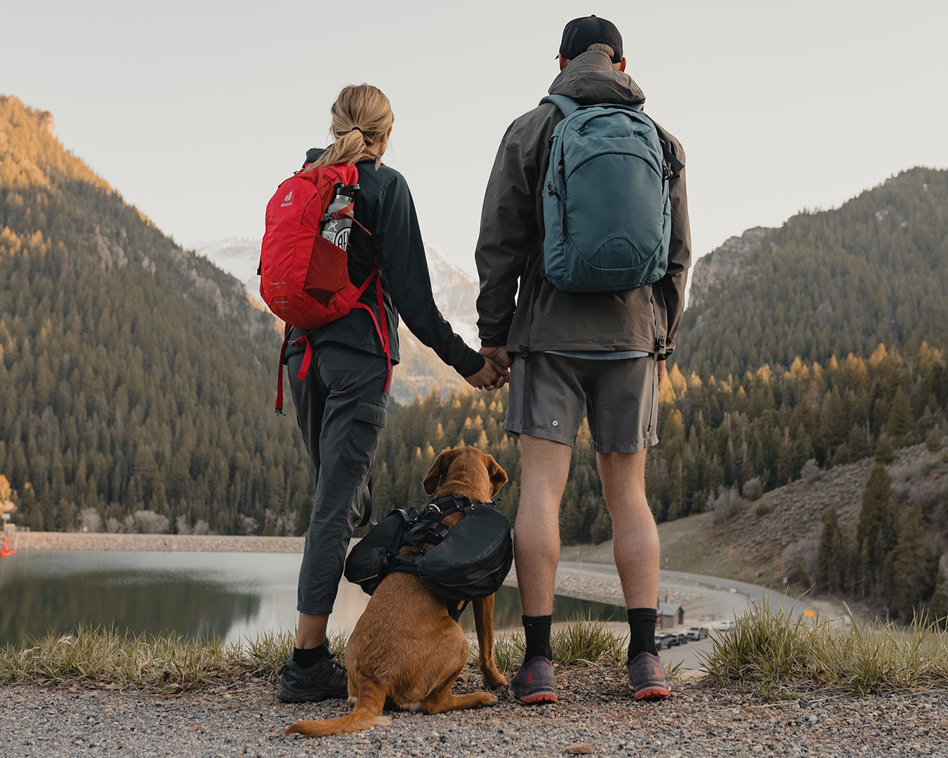 Couple at the summit with their dog who's wearing the Säker Ascension Dog Pack