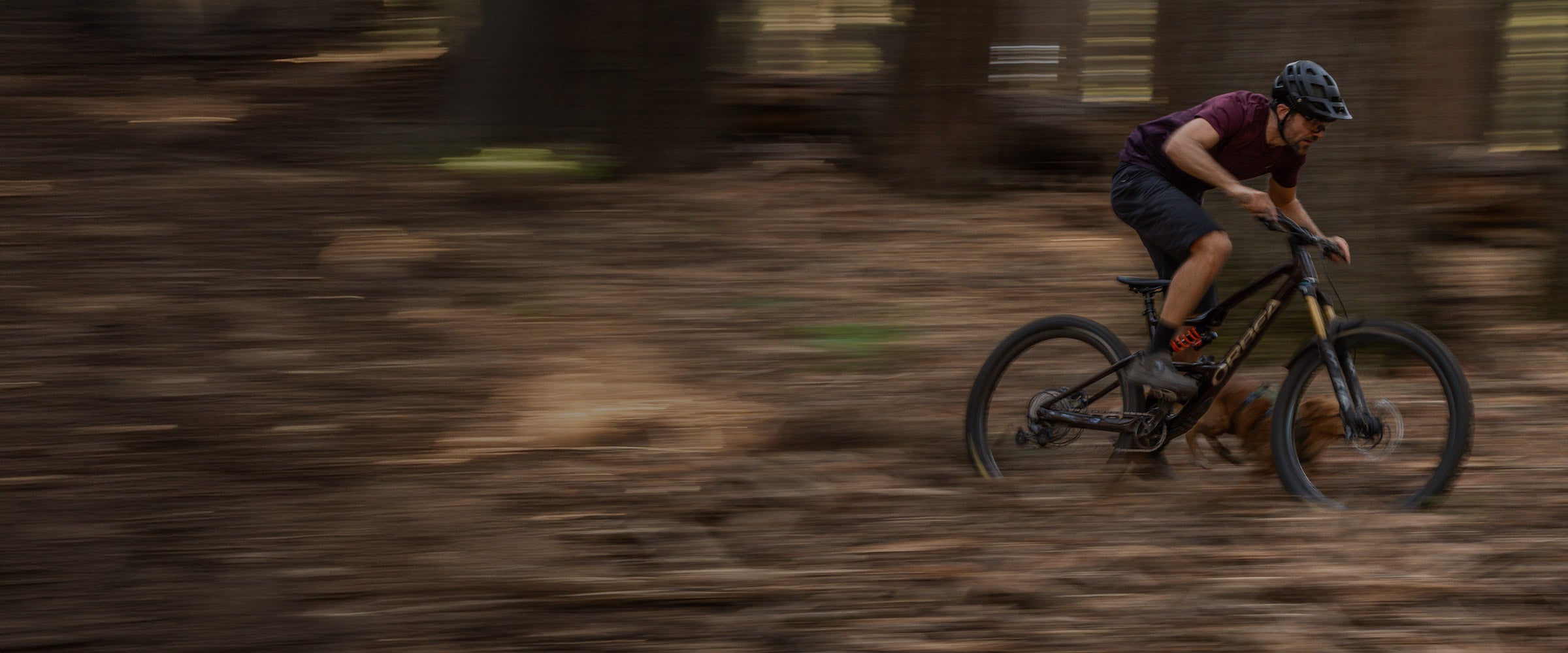 Fruitsnackzach and maisey riding full speed in mtb downhill. Maisey wears the Muse harness in Trail Green.