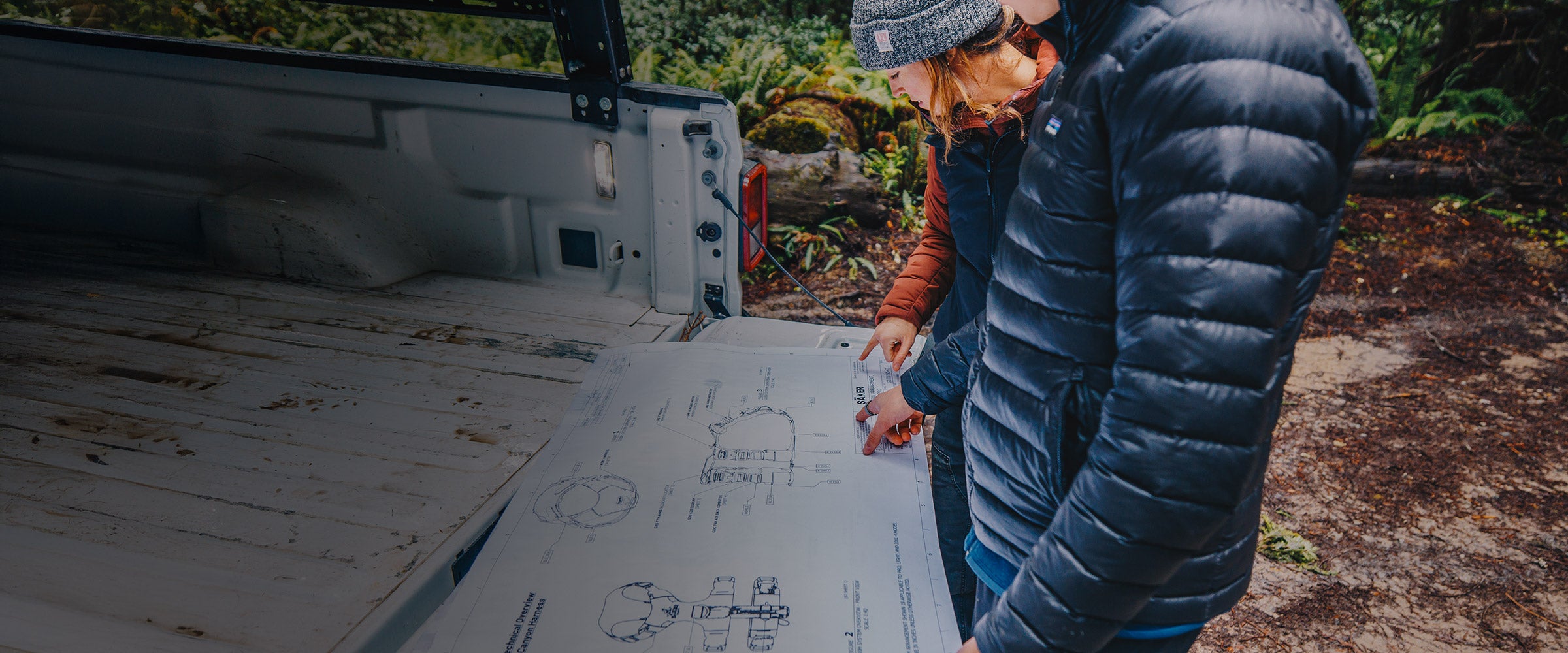 Saker team looking at the plans of the Canyon harness in the Redwoods, California