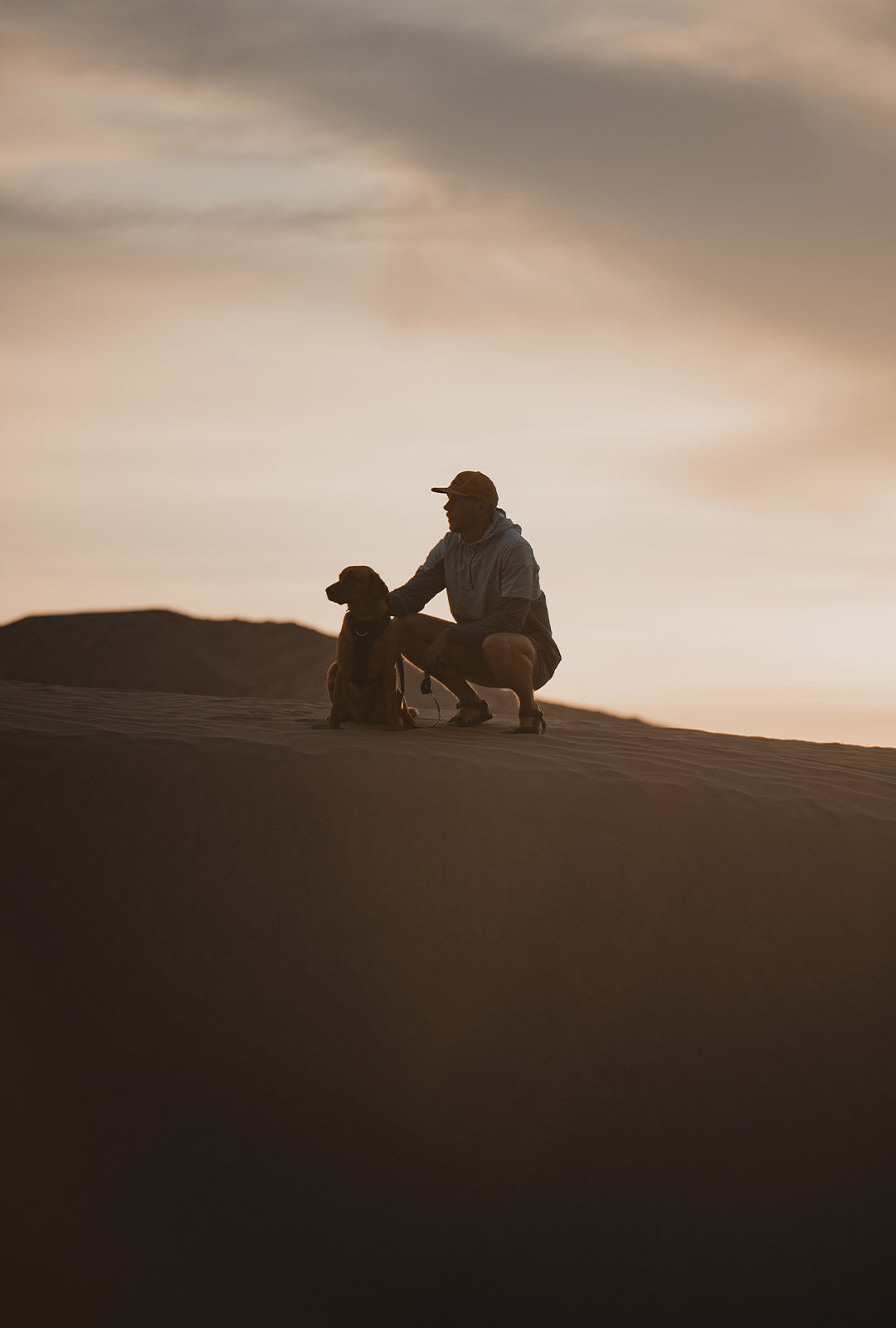 Man next to his dog in the sahara desert wearing the Ascension original prototype