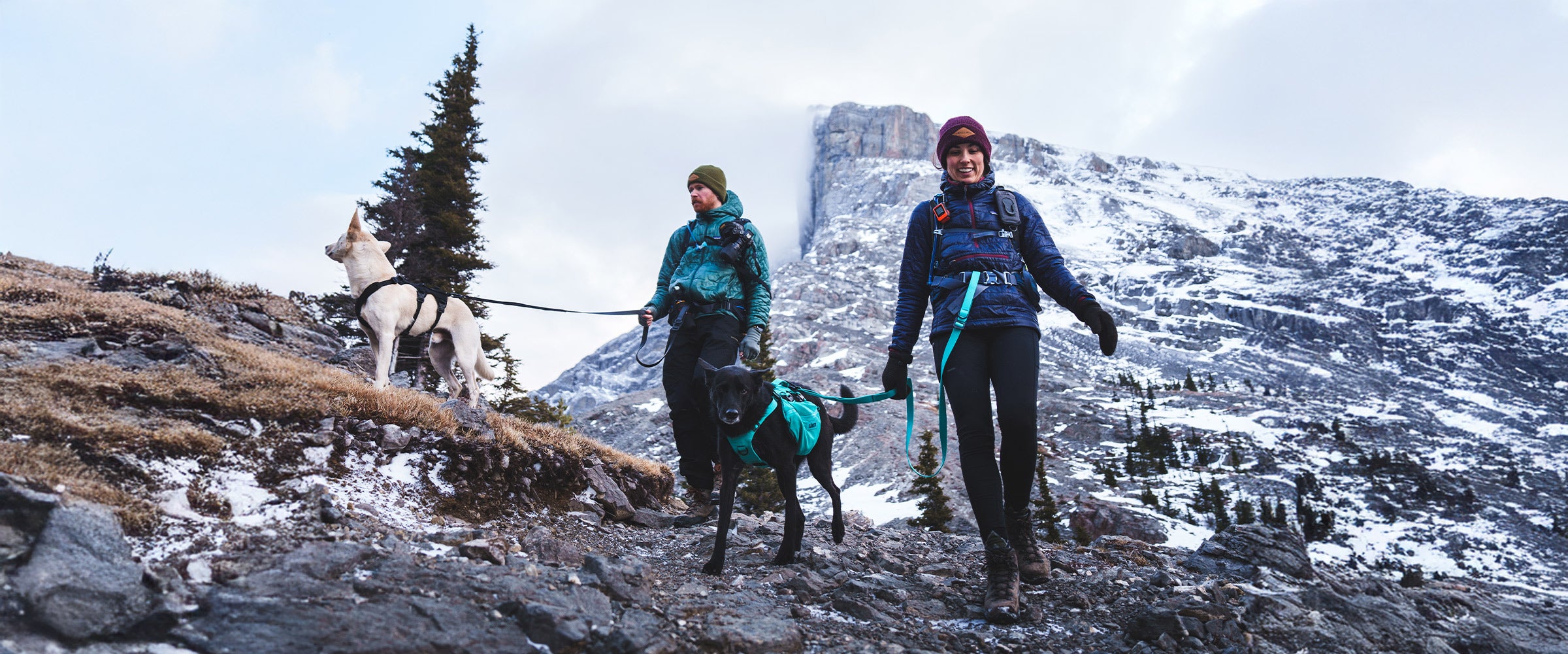 Andrsnpck couple hiking down in banff with their Muse harnesses