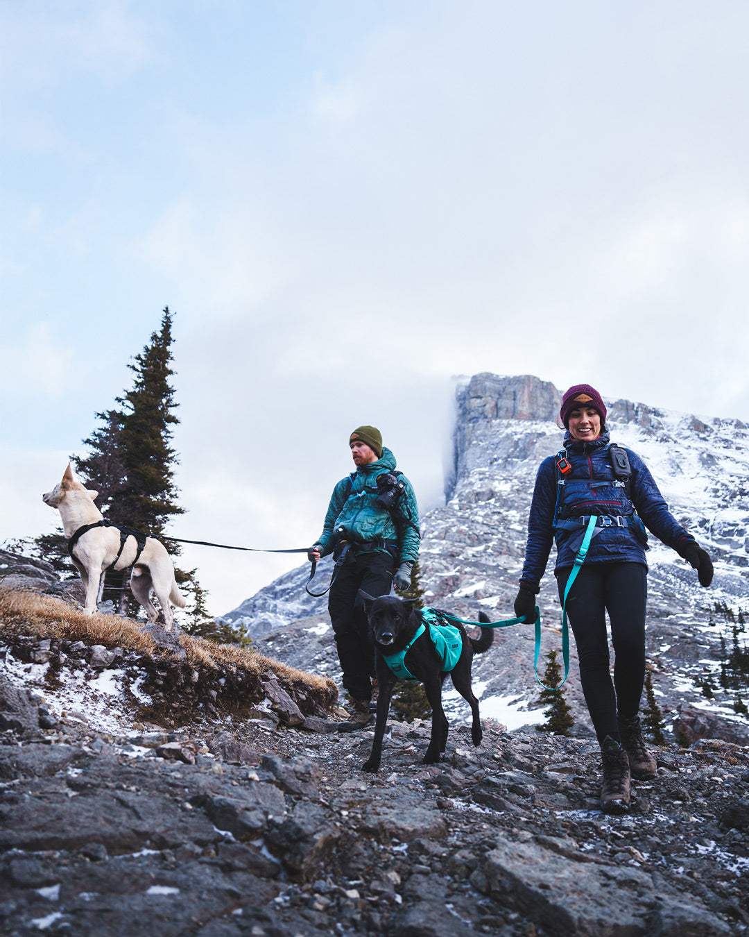 Andrsnpck couple hiking down in banff with their Muse harnesses